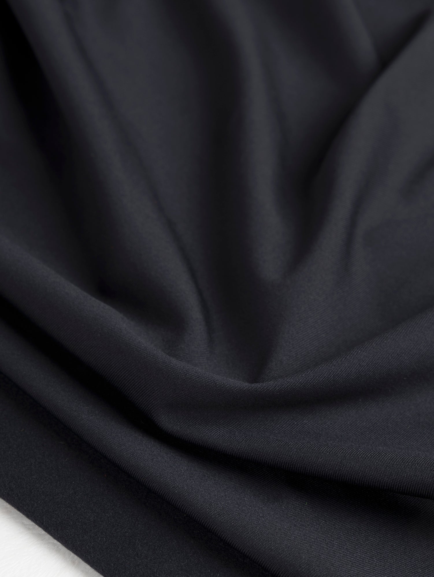 F-PES035-001-Poly-Brushed-Stretch-Jersey-Knit-Deadstock-Black-Core-Fabrics-scrunched.JPG