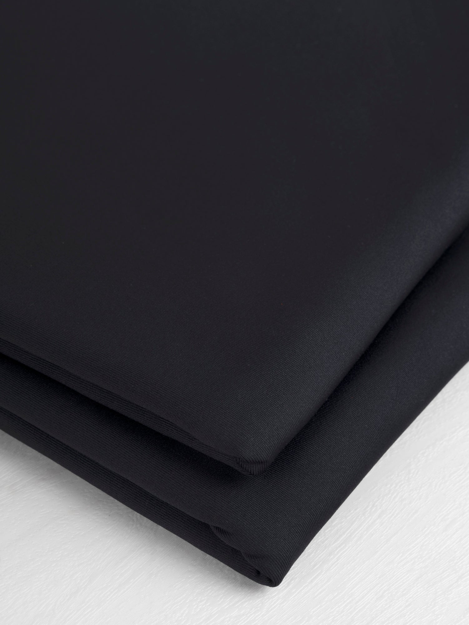 F-PES035-001-Poly-Brushed-Stretch-Jersey-Knit-Deadstock-Black-Core-Fabrics-fold.JPG