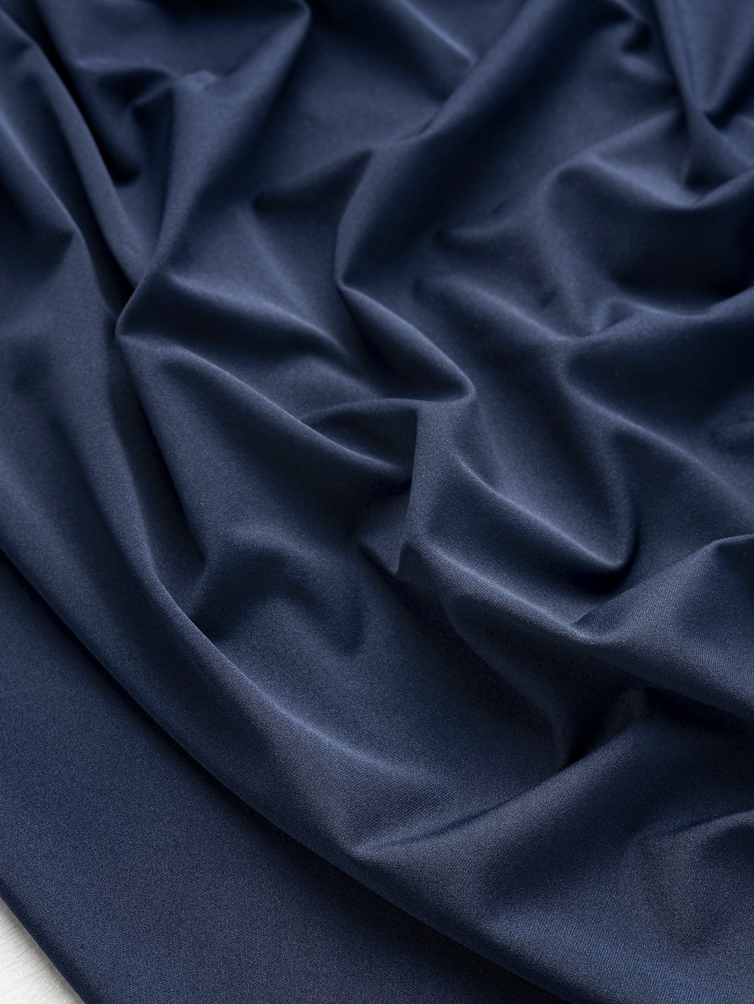 F-DEA130-Recycled-Polyester-Stretch-Knit-Deadstock-Navy-Core-Fabrics-scrunched.JPG