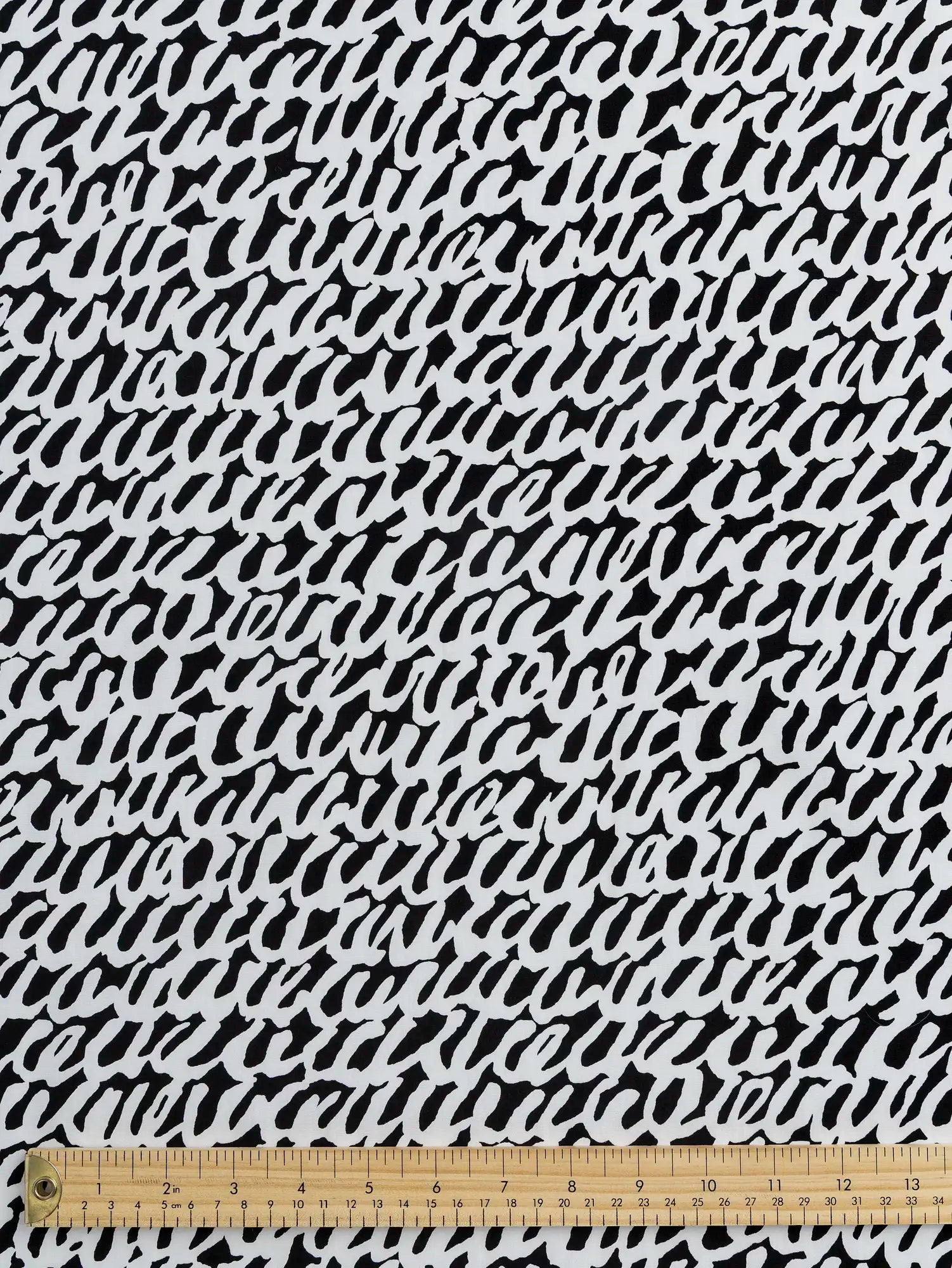 F-COT400-003-Scribble-Print-Japanese-Cotton-Lawn-Black-and-White-Core-Fabrics-ruler.webp