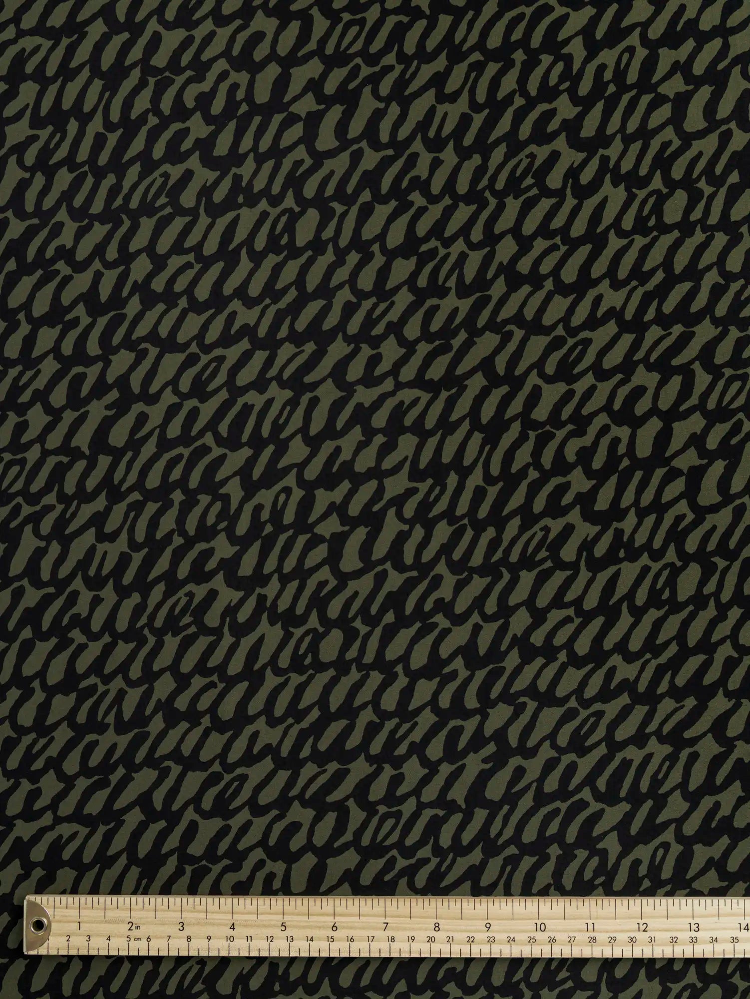 F-COT400-002-Scribble-Print-Japanese-Cotton-Lawn-Olive-and-Black-Core-Fabrics-ruler.webp