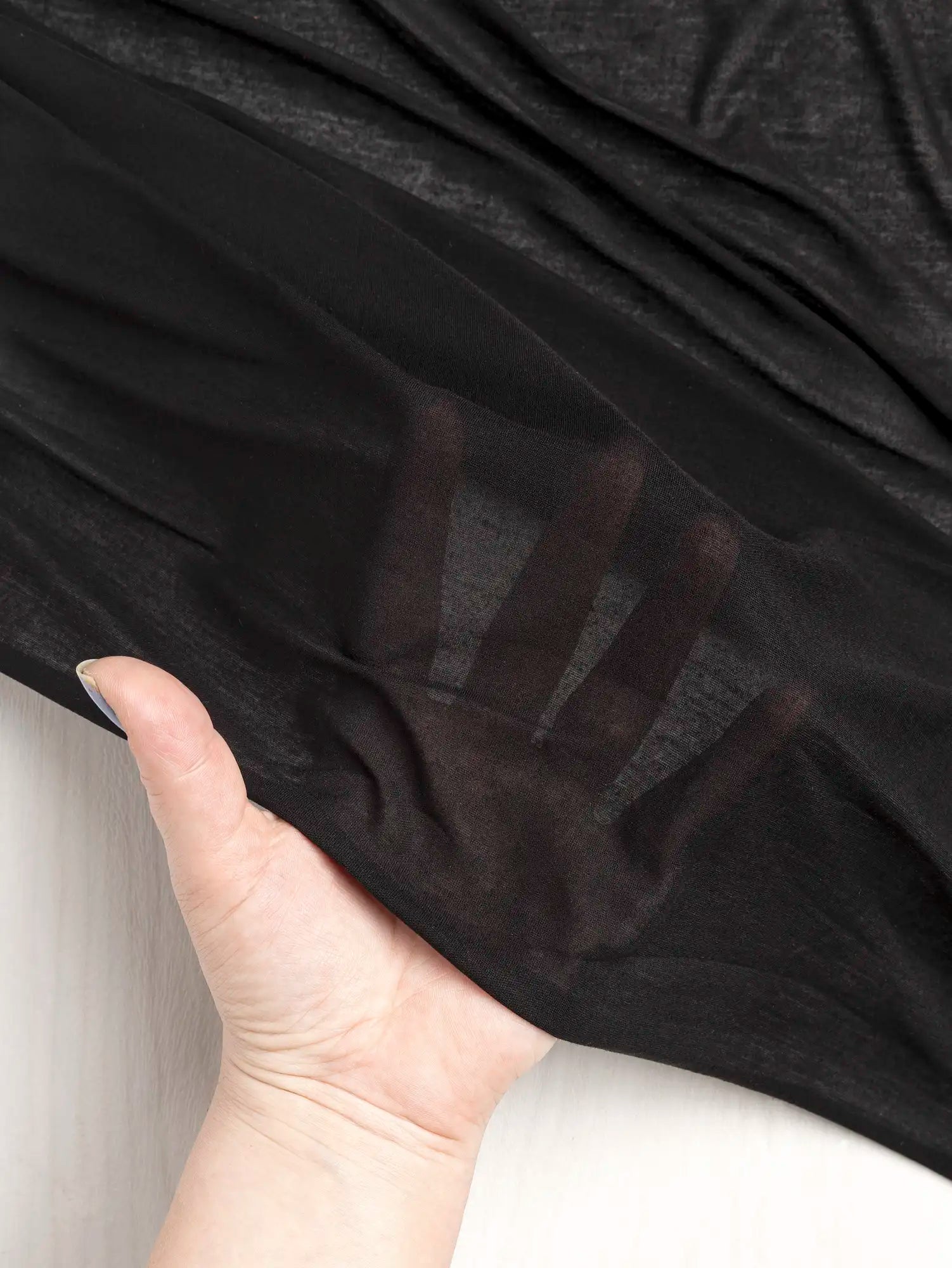 F-DEA203-001-Semi-Sheer-Viscose-Stretch-Knit-Deadstock-Black-Core-Fabrics-transparency.webp