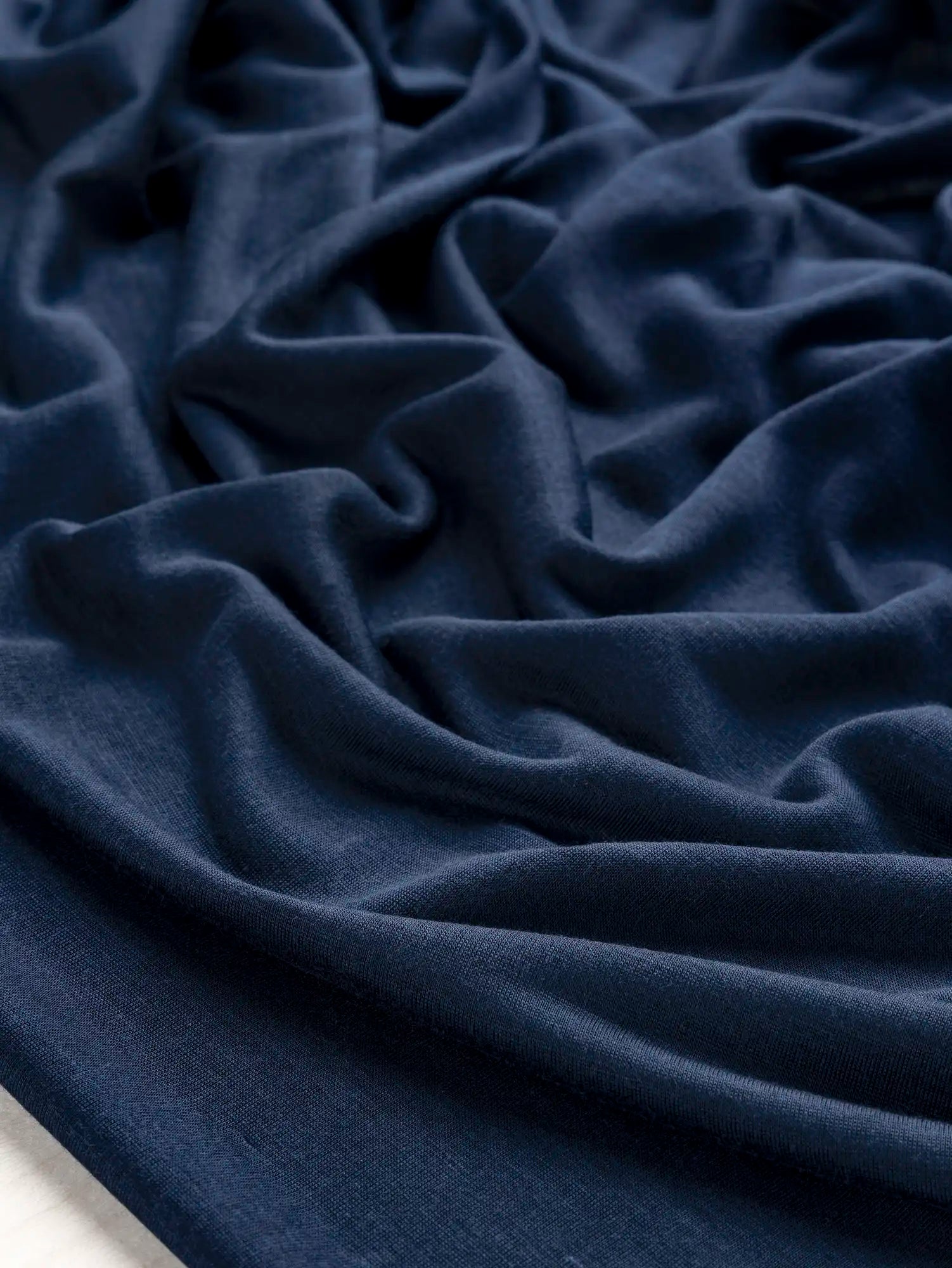 F-DEA203-003-Semi-Sheer-Viscose-Stretch-Knit-Deadstock-Midnight-Blue-Core-Fabrics-scrunched.webp