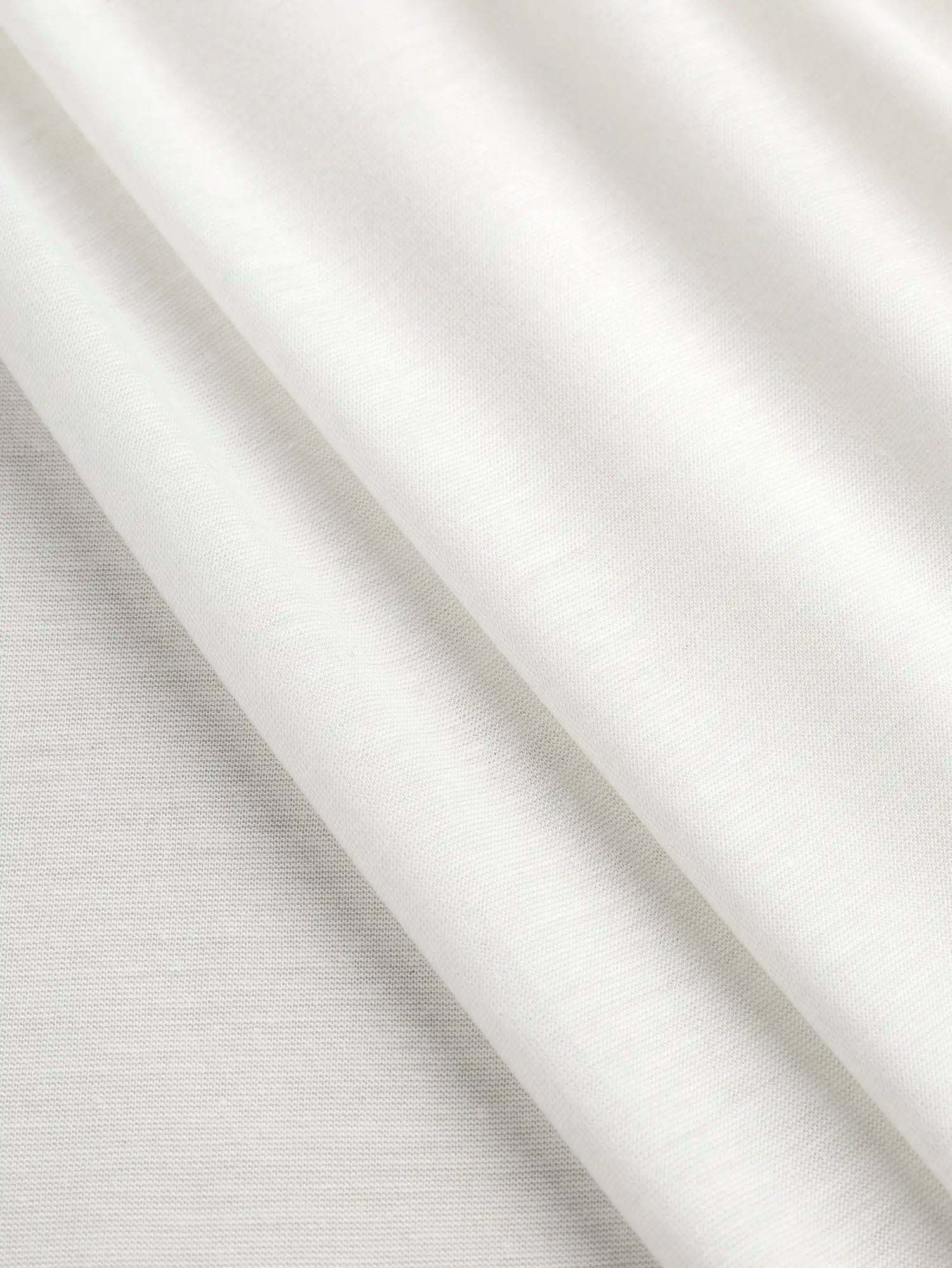 F-DEA203-002-Semi-Sheer-Viscose-Stretch-Knit-Deadstock-White-Core-Fabrics-fold.webp