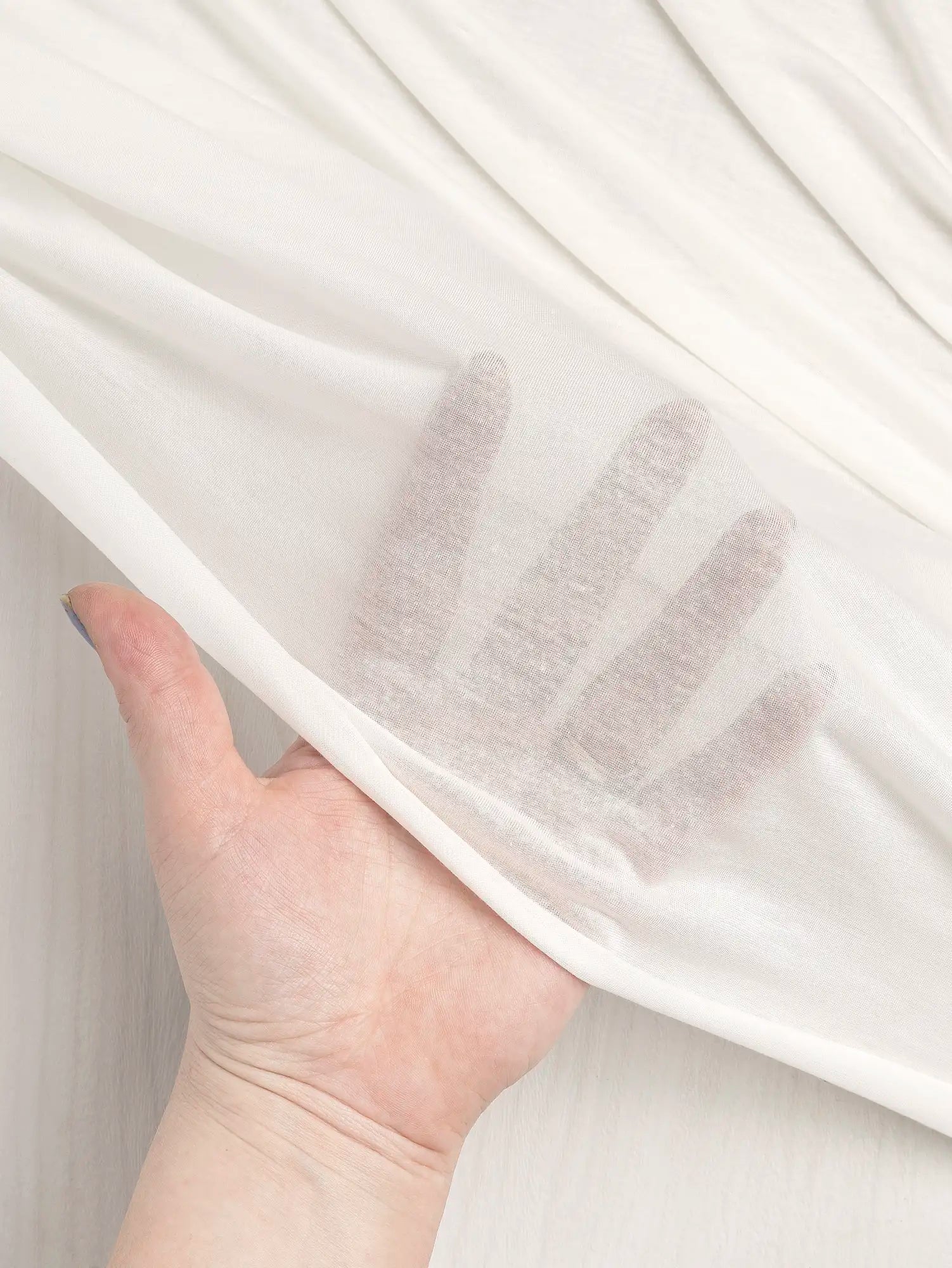 F-DEA203-002-Semi-Sheer-Viscose-Stretch-Knit-Deadstock-White-Core-Fabrics-transparency.webp