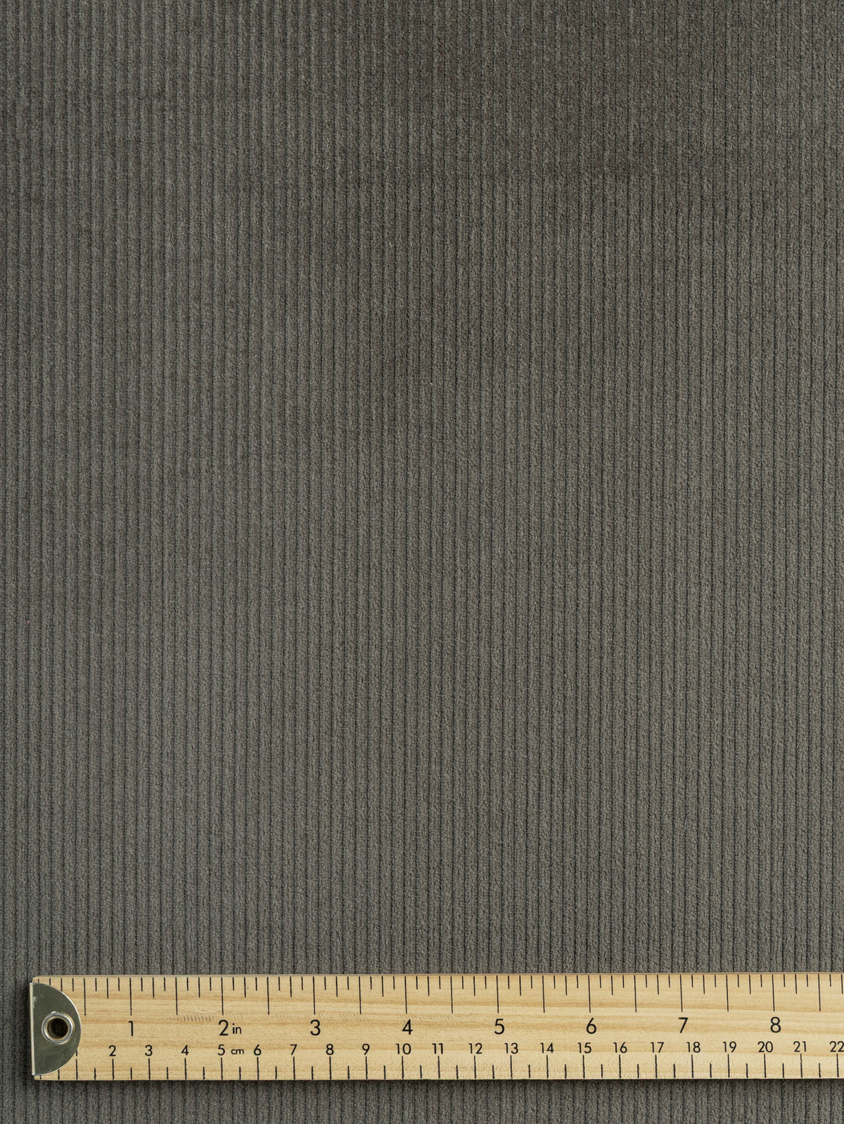 F-COT507-003-Slight-Stretch-8-Wale-Cotton-Corduroy-Olive-Core-Fabrics-ruler.webp