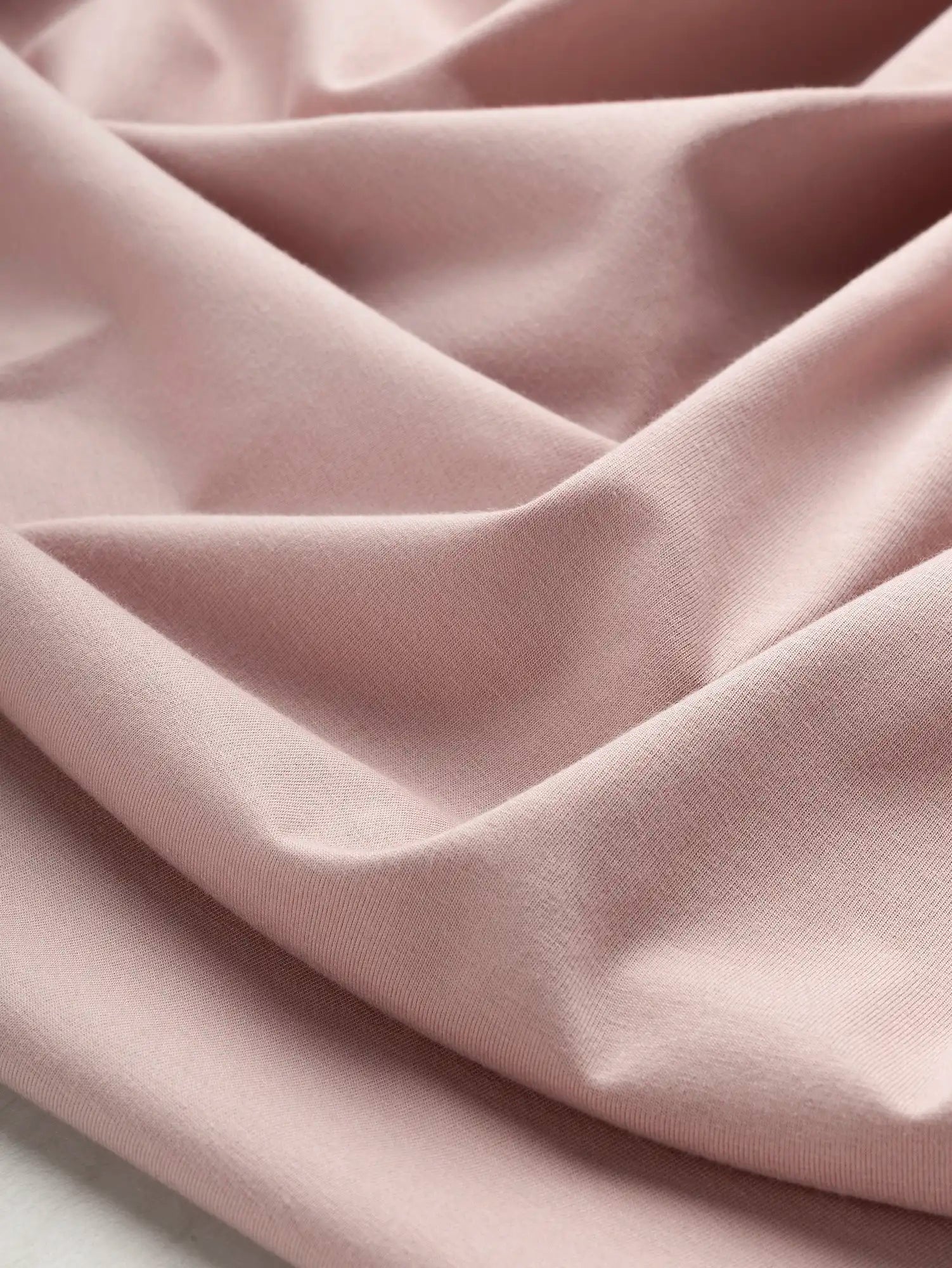 F-DEA232-Stretch-Cotton-Spandex-Jersey-Deadstock-Dusty-Rose-Core-Fabrics-scrunched.webp