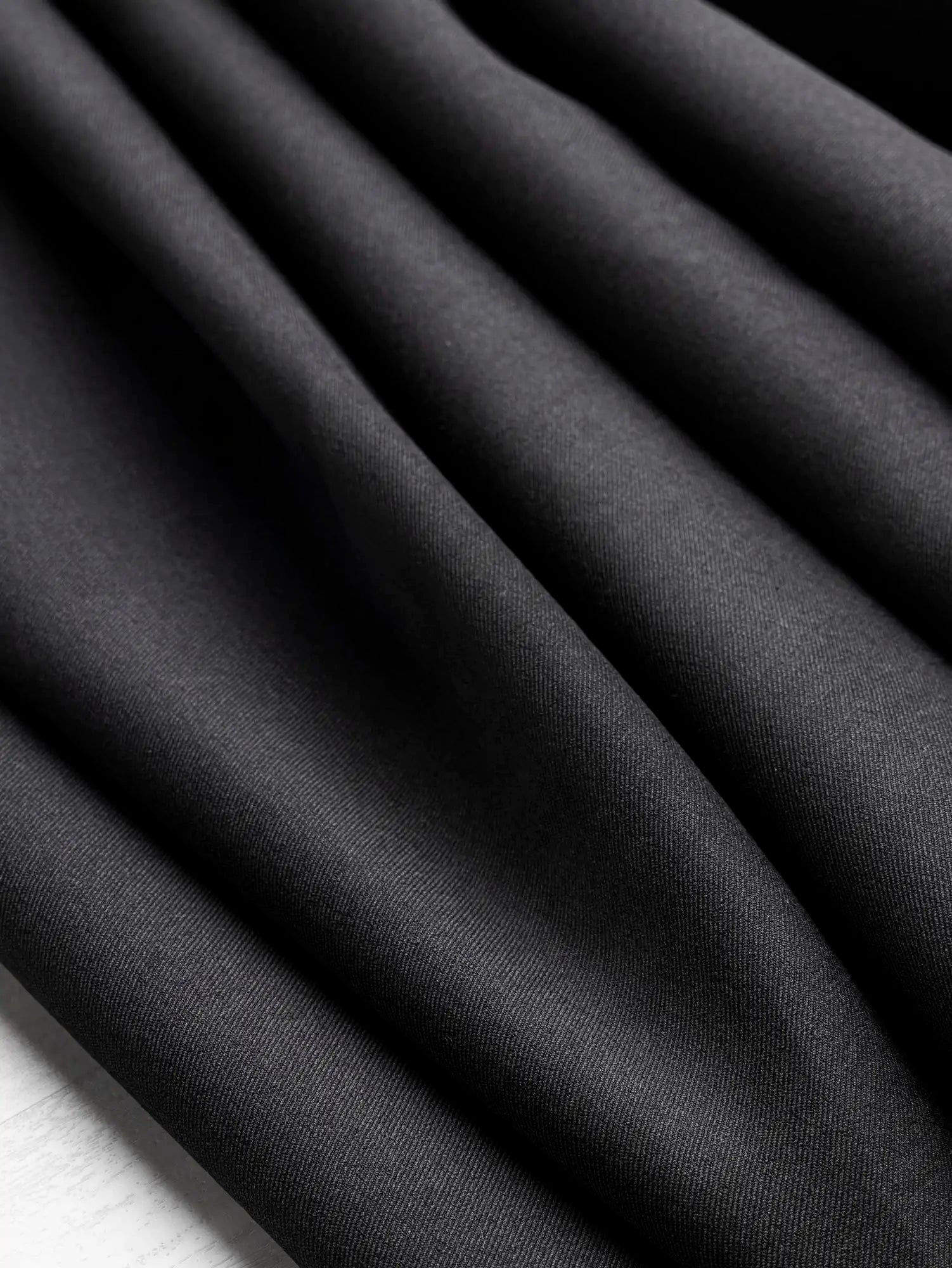 F-DEA246-Stretch-Cotton-Spandex-Twill-Deadstock-Black-Core-Fabrics-scrunched.webp