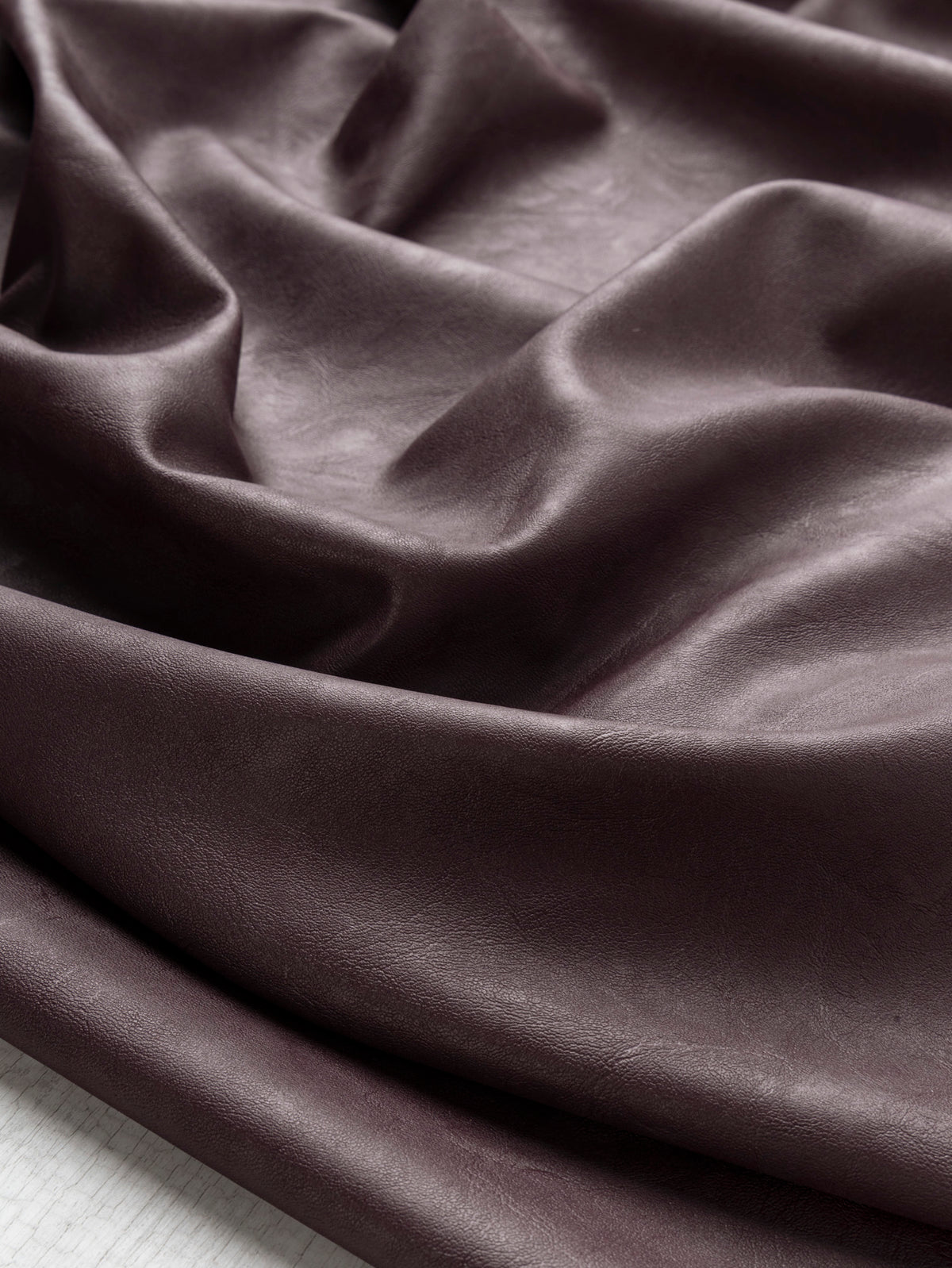 F-DEA261-Stretch-Faux-Leather-Deadstock-Burgundy-Core-Fabrics-scrunched.webp