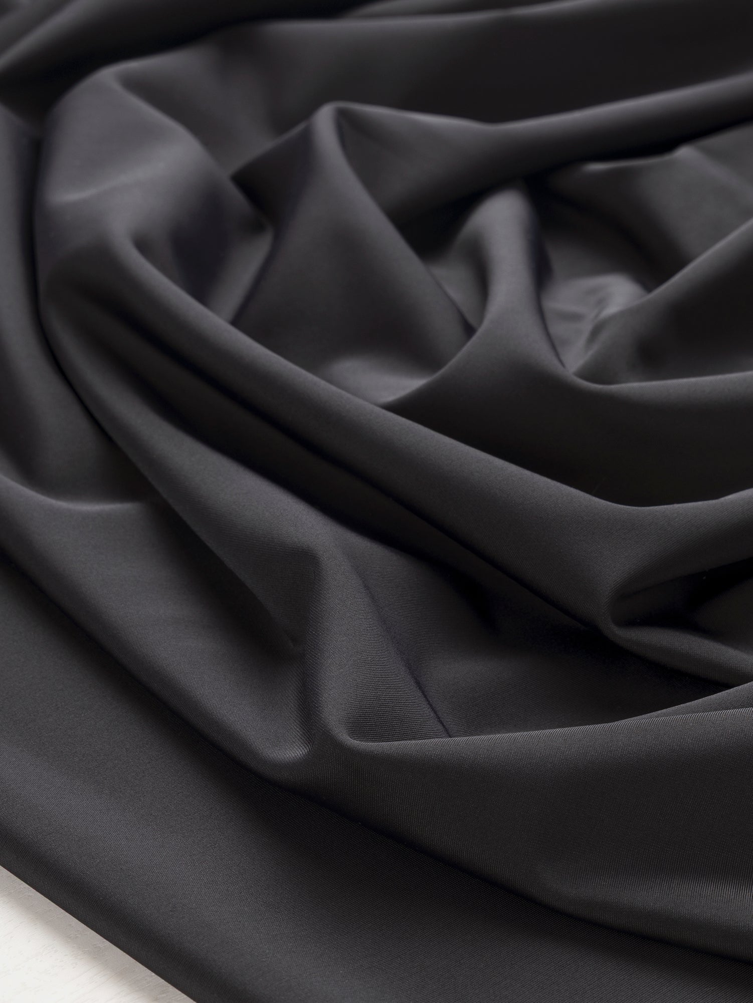 F-DEA101-Stretch-Poly-Elastane-Knit-Deadstock-Black-Core-Fabrics-scrunched.JPG