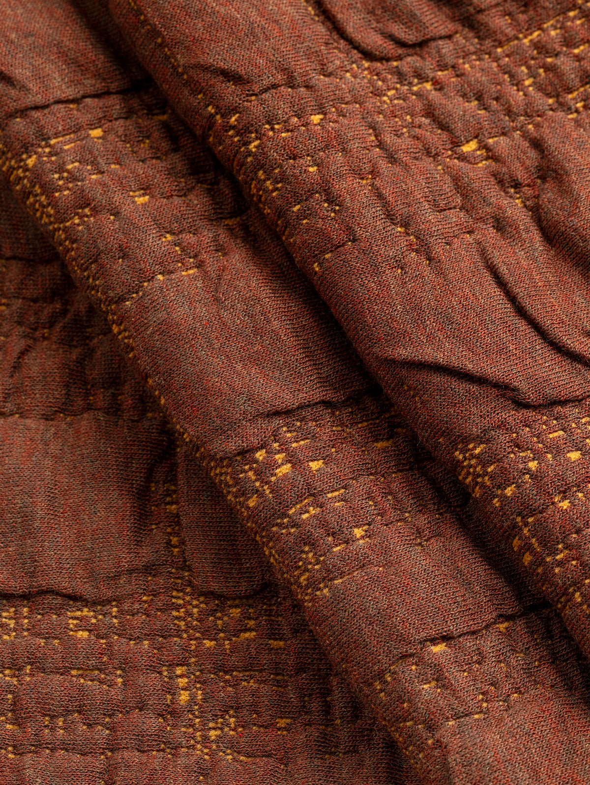 F-DEA256-003-Stretch-Quilted-Jacquard-Knit-Deadstock-Mahogany-Core-Fabrics-fold.webp