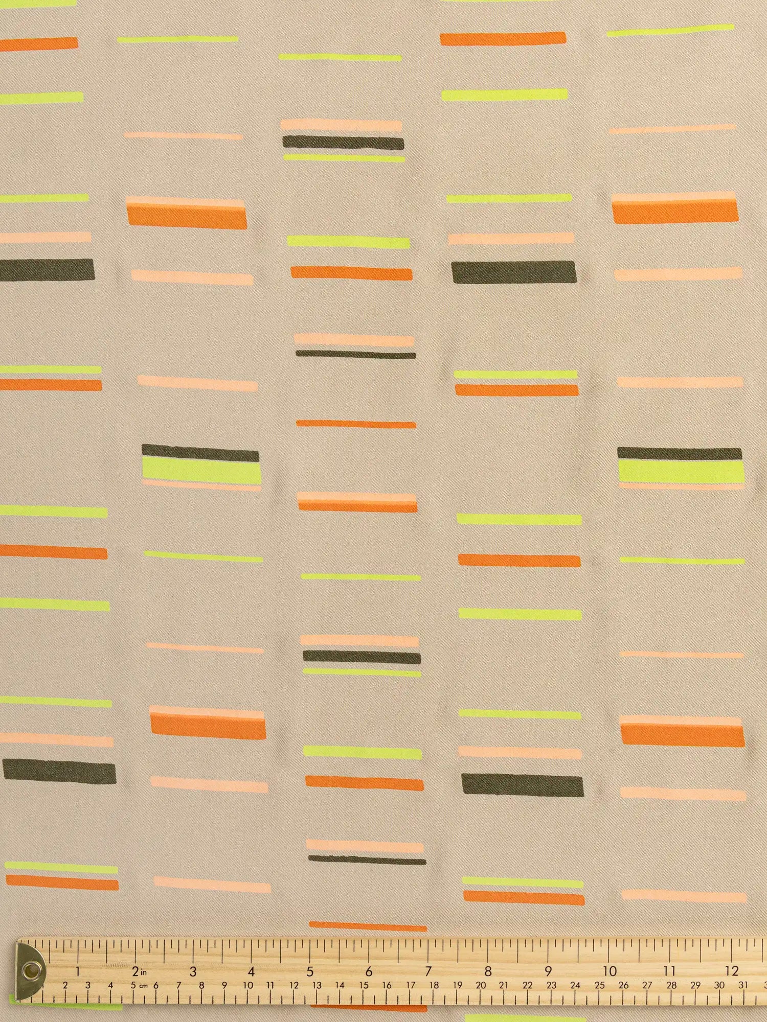F-DEA187-Stripe-Print-Viscose-Twill-Deadstock-Sand-Orange-and-Chartreuse-Core-Fabrics-ruler.webp