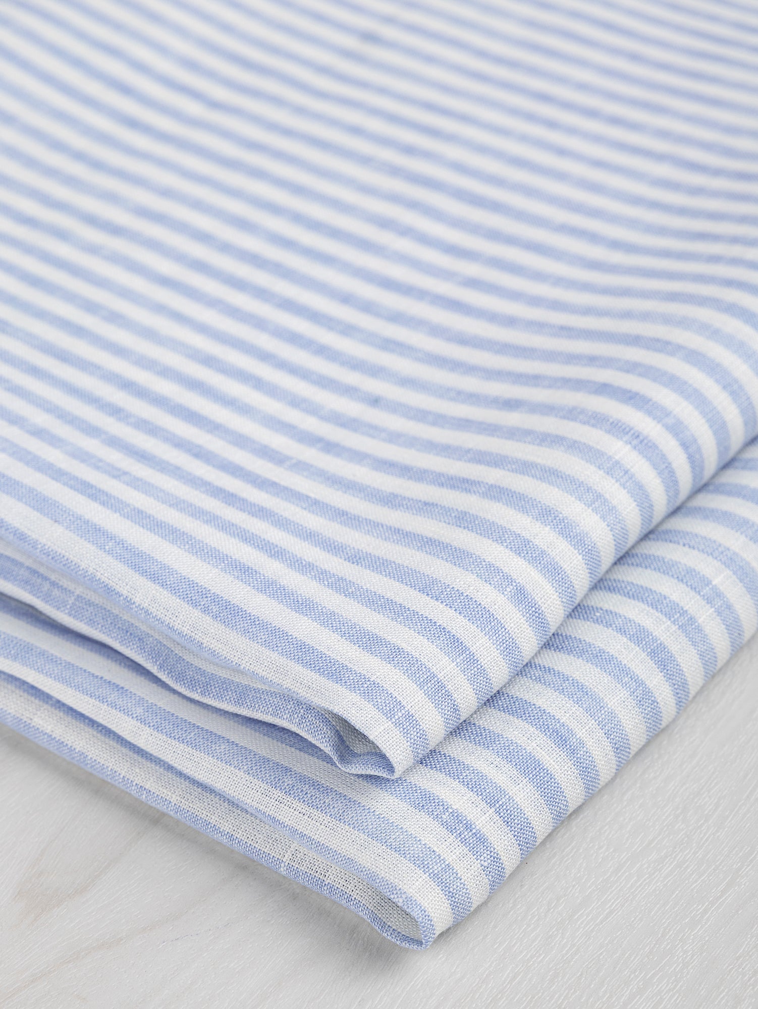 F-LIN043-003-Striped-Linen-Shirting-Light-Blue-and-White-Core-Fabrics-fold.JPG