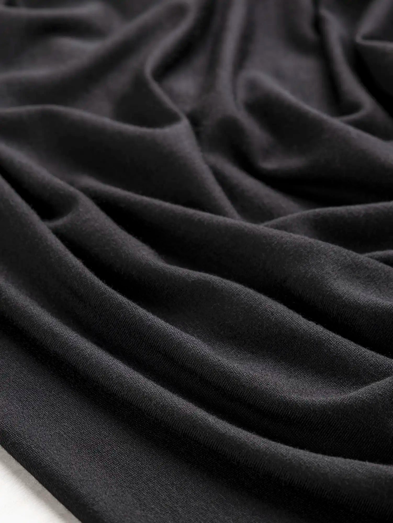 F-DEA202-Tencel-Cotton-Spandex-Stretch-Knit-Deadstock-Black-Core-Fabrics-scrunched.webp
