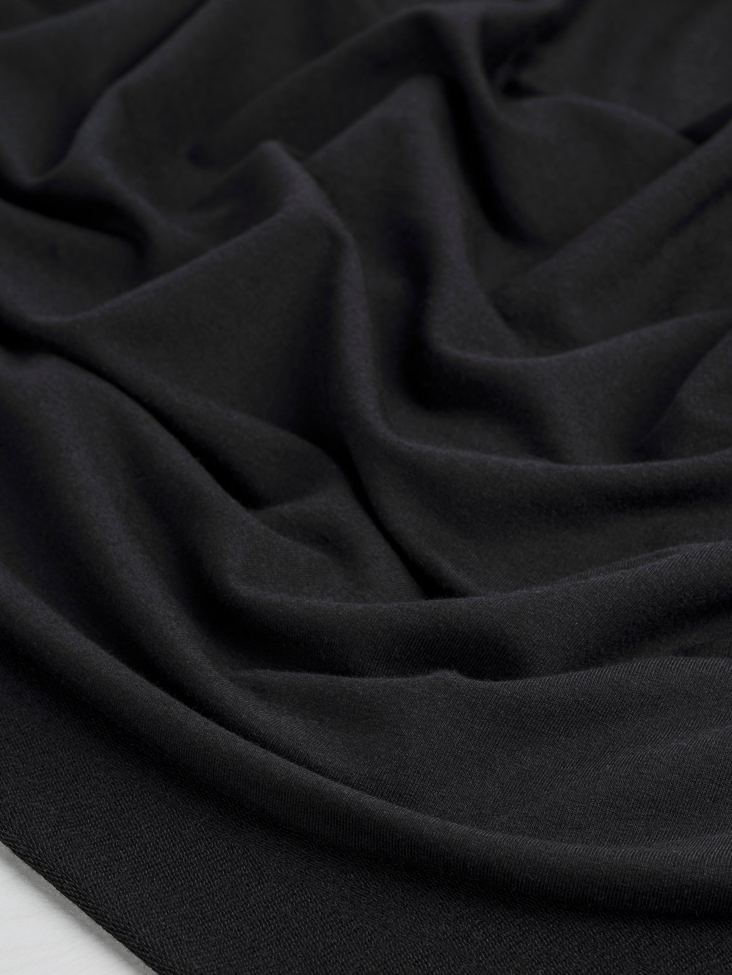 F-TEN014-001-Tencel-Lyocell-Organic-Cotton-Stretch-French-Terry-Black-Core-Fabrics-scrunched