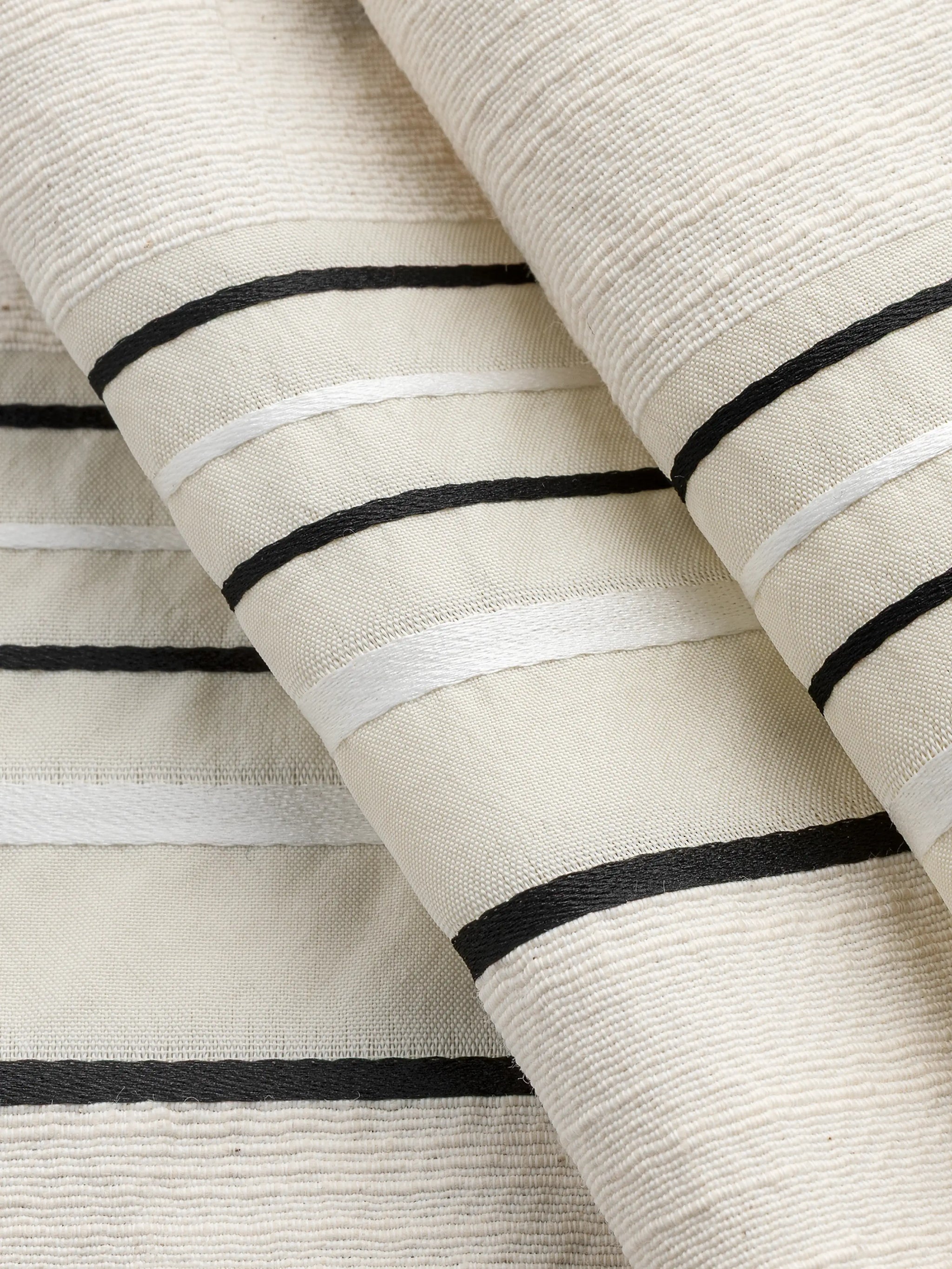 F-DEA145-Textured-Stripe-Cotton-Deadstock-Cream-White-and-Black-Core-Fabrics-fold.webp