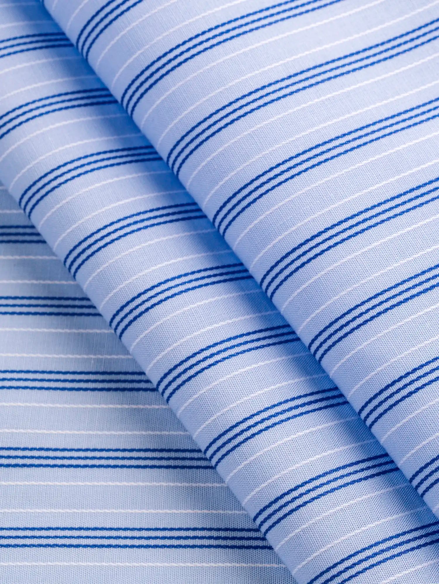 F-COT456-002-Textured-Stripe-Organic-Cotton-Shirting-Sky-Ocean-and-White-Core-Fabrics-fold.webp