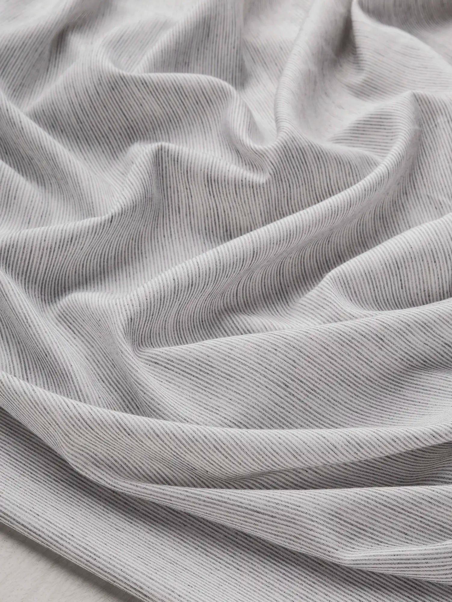 F-DEA215-ThinStripe-Cotton-Voile-Deadstock-White-and-Cloud-Core-Fabrics-scrunched.webp