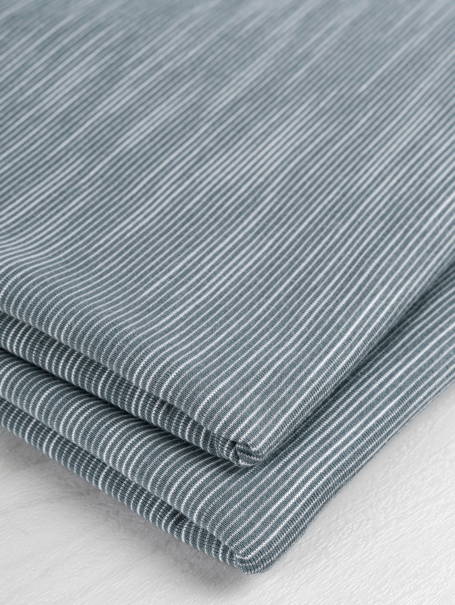 F-DEA020-Tiny-Stripe-Cotton-Spandex-Jersey-Knit-Deadstock-Blue-and-White-Core-Fabrics-fold.JPG