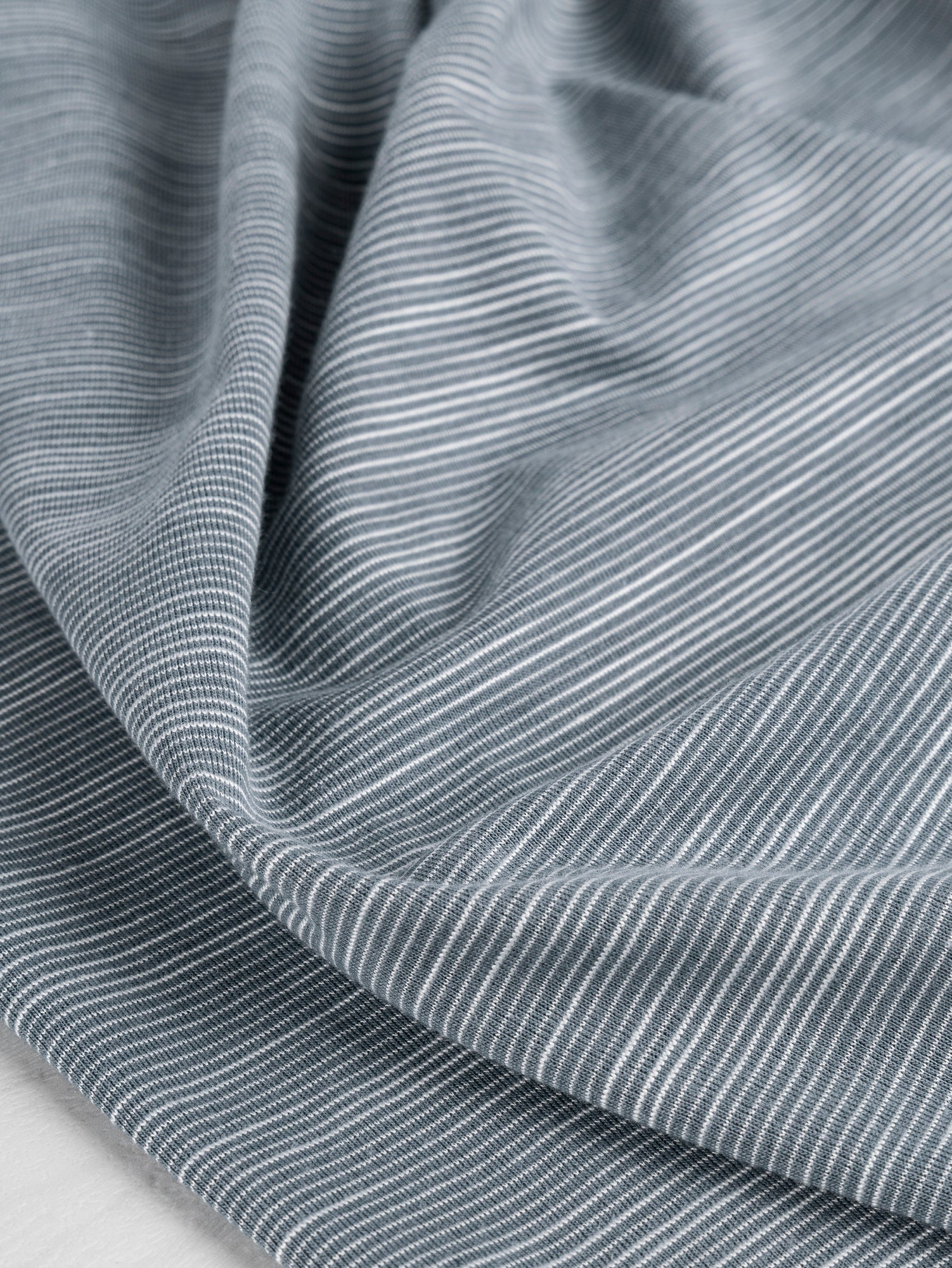F-DEA020-Tiny-Stripe-Cotton-Spandex-Jersey-Knit-Deadstock-Blue-and-White-Core-Fabrics-scrunched.JPG
