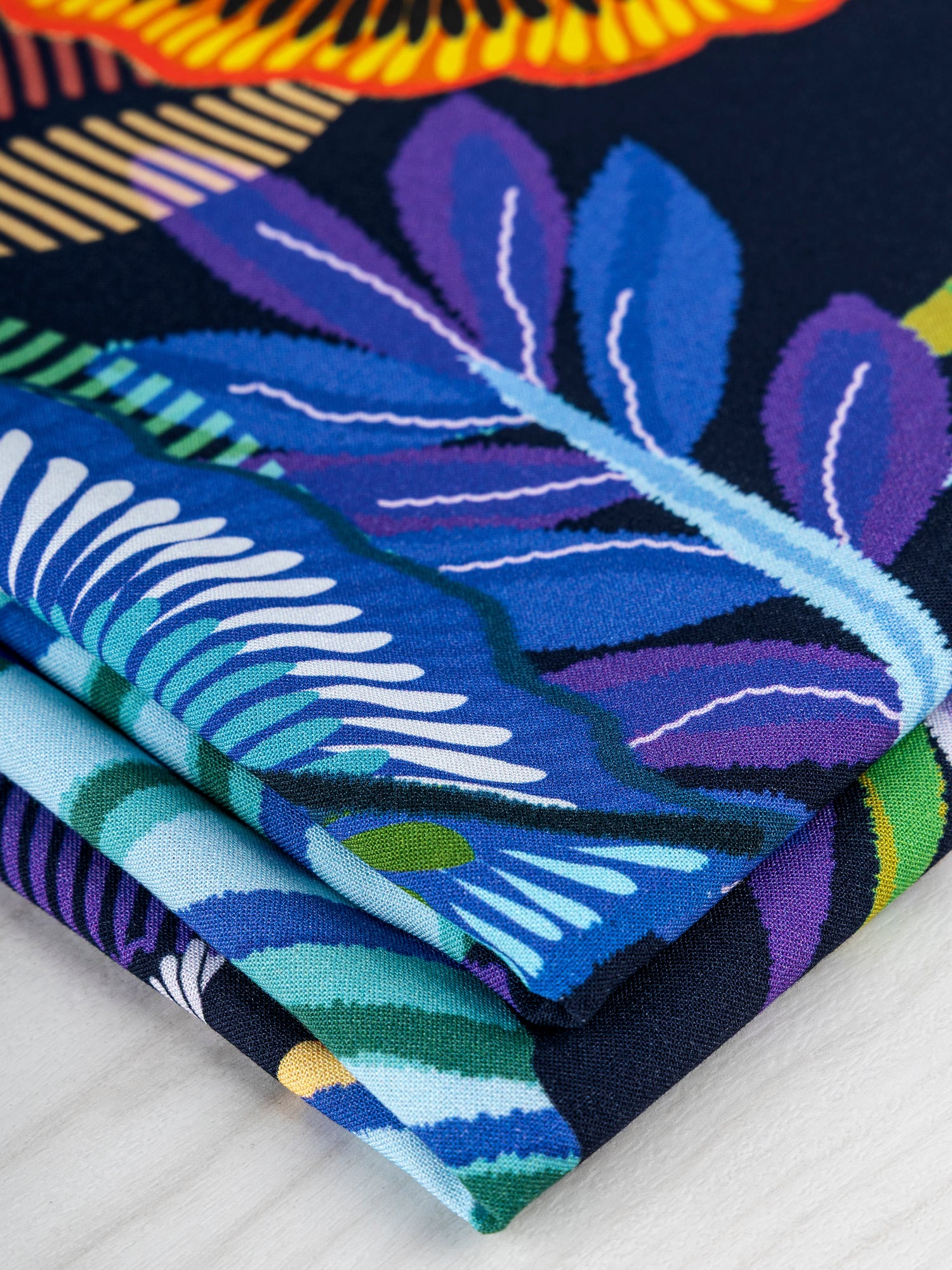 F-VIS246-Tropical-Leaf-Print-Ecovero-Viscose-Black+Pink+Orange+Violet-Core-Fabrics-fold.JPG