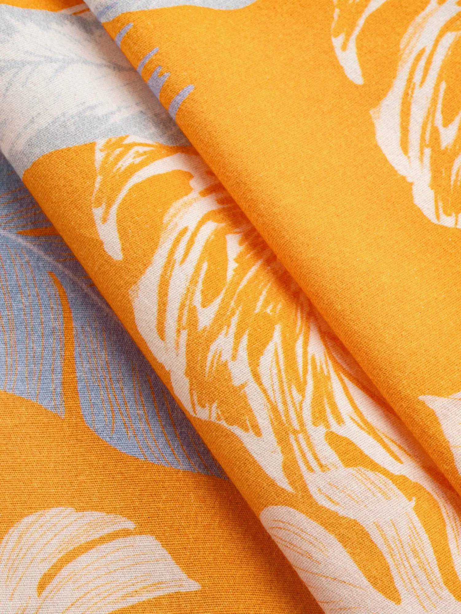 F-DEA242-Tropical-Print-Stretch-Cotton-Woven-Deadstock-Orange-Lavender-and-Mist-Core-Fabrics-fold.webp