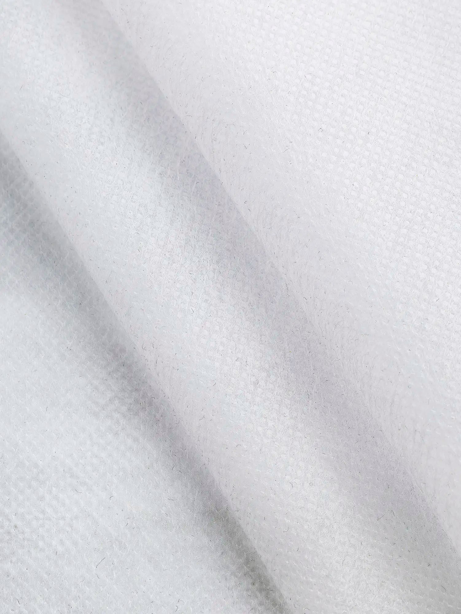 N-INT015-002-Ultra-Light-Non-Woven-Sew-On-Interfacing-White-Core-Fabrics-fold.webp