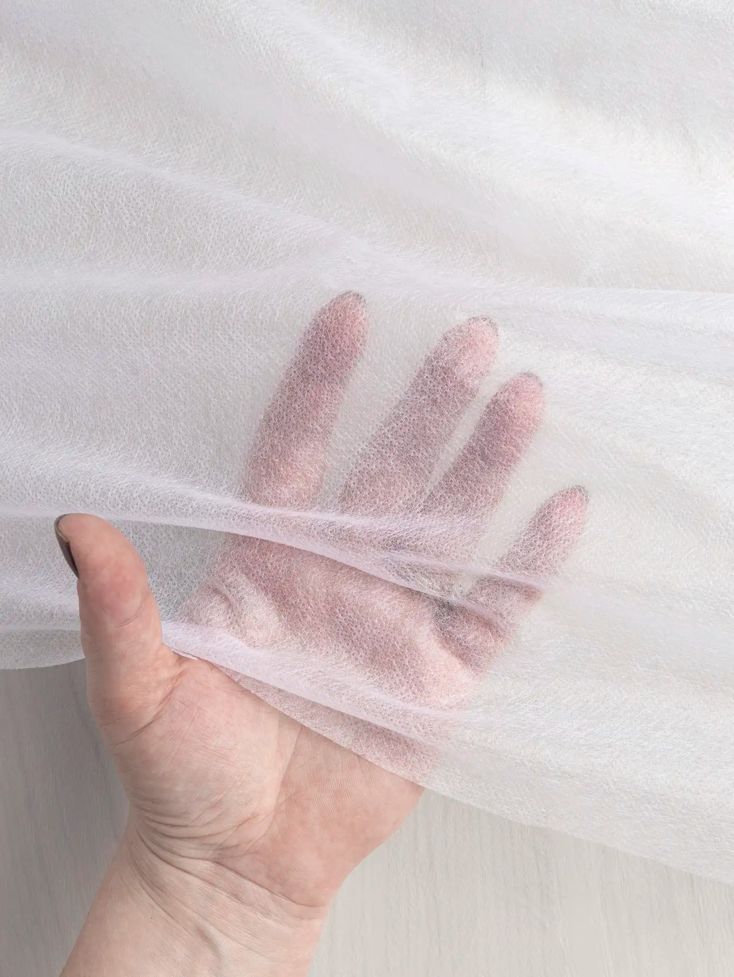 N-INT015-002-Ultra-Light-Non-Woven-Sew-On-Interfacing-White-Core-Fabrics-transparency.webp