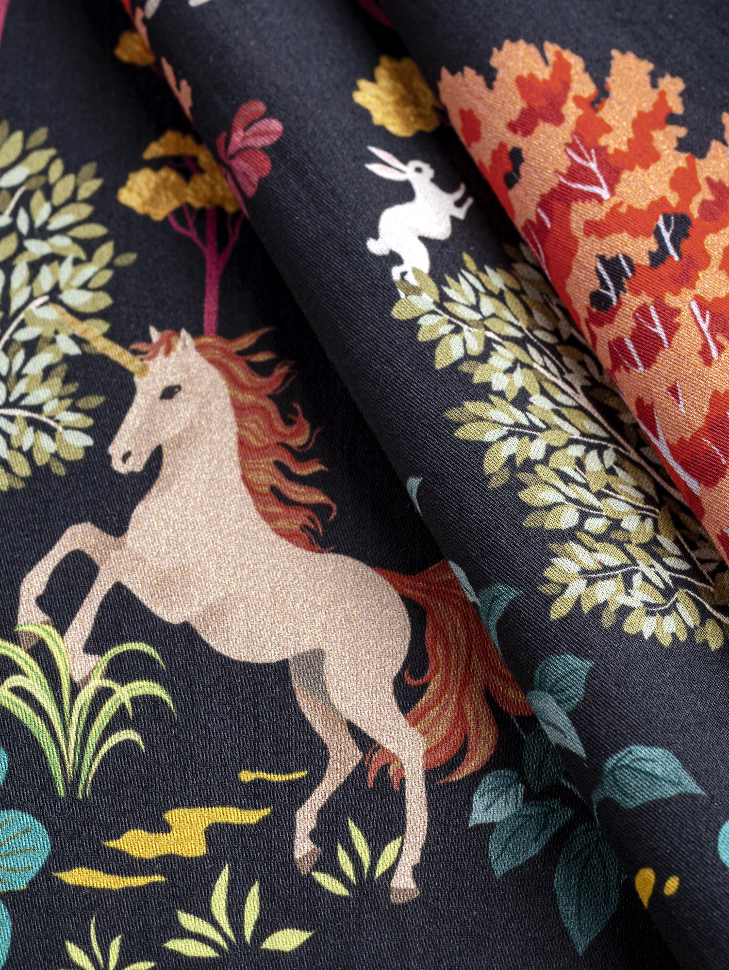F-COT388-Unicorn-Print-Cotton-Lawn-Navy-Multicolour-Core-Fabrics-fold.JPG