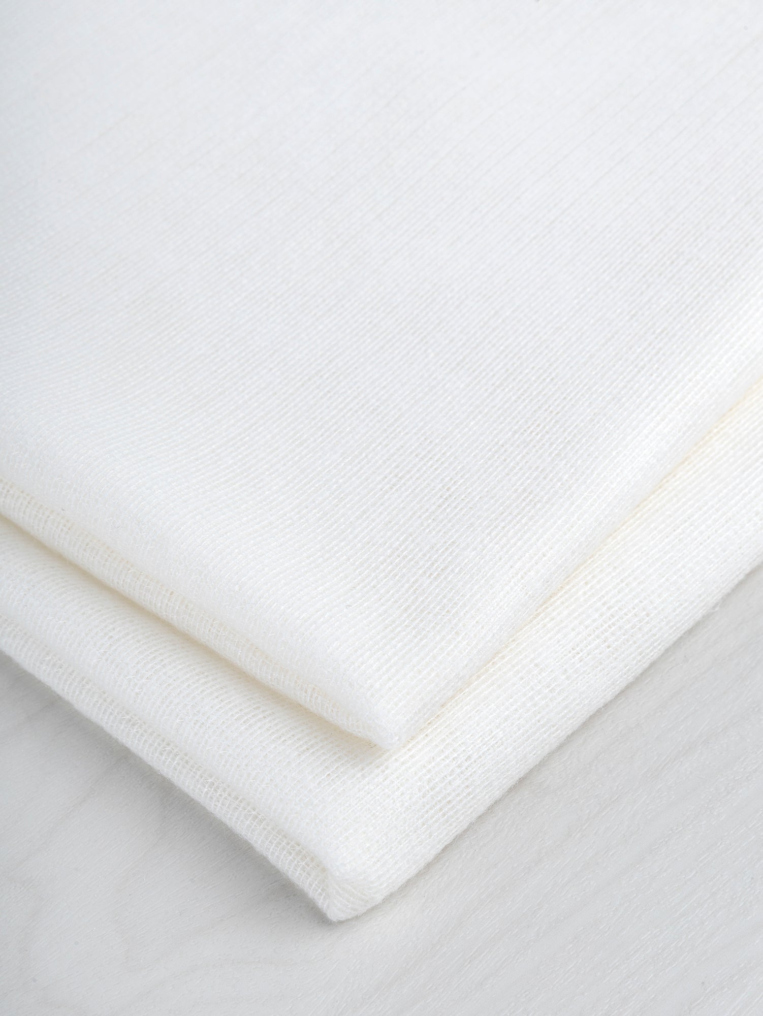 N-INT013-001-Viscose-Poly-Midweight-Fusible-Weft-Interfacing-for-Tailoring- White-Core-Fabrics-fold.JPG