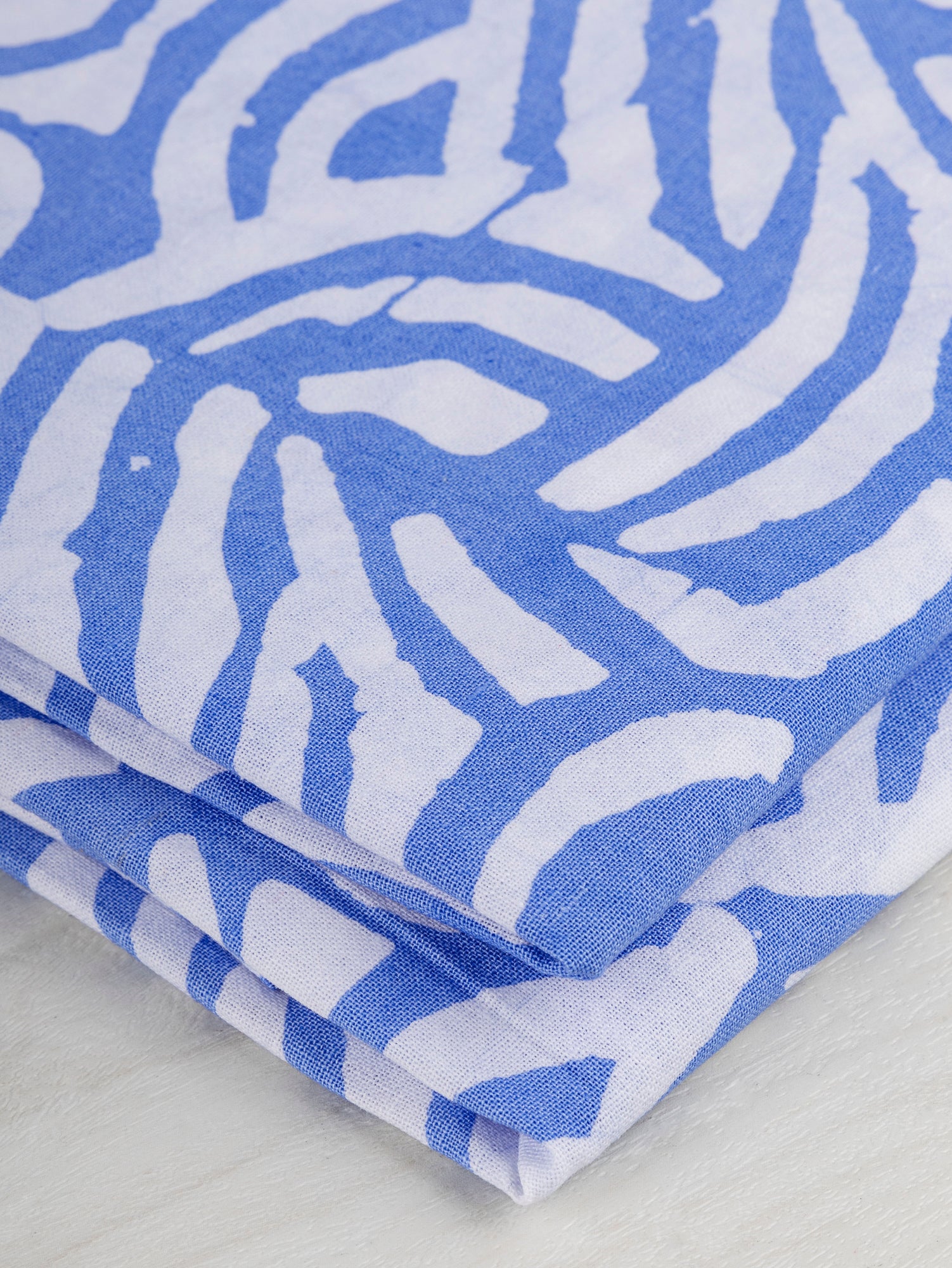 F-COT321-Wave-Artisanal-Cotton-Batik-Light-Blue-and-White-Core-Fabrics-fold