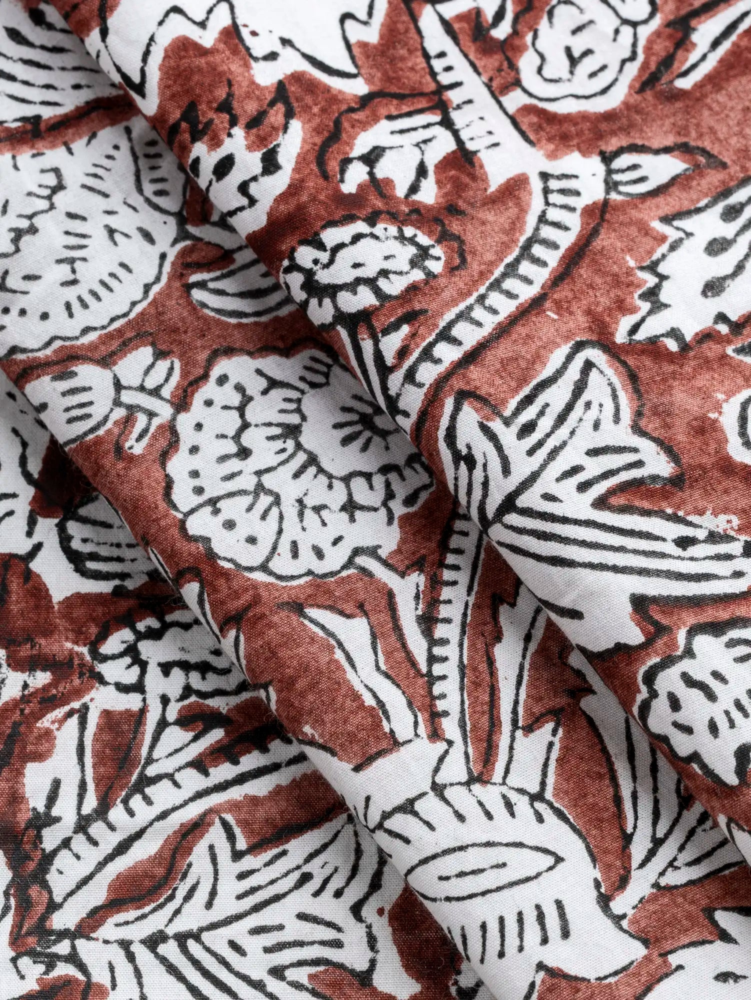 F-COT487-Woodland-Floral-Block-Print-Cotton-Poplin-Chestnut-Ivory-and-Black-Core-Fabrics-fold.webp