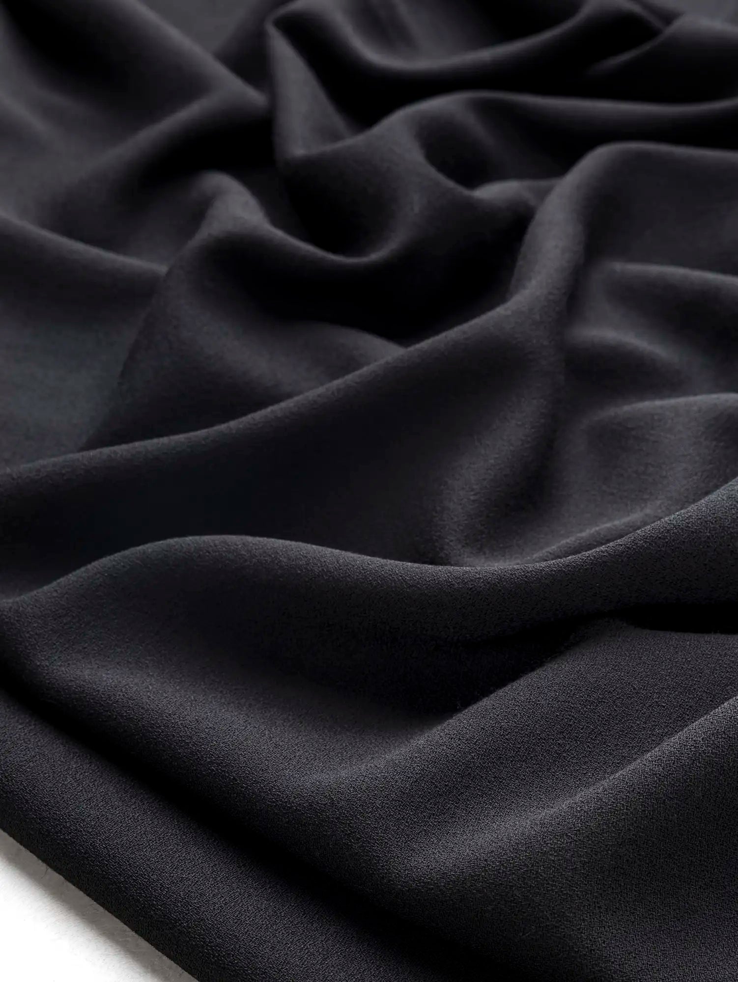 F-WOL152-Wool-Crepe-Italian-Suiting-Deadstock-Black-Core-Fabrics-scrunched.webp