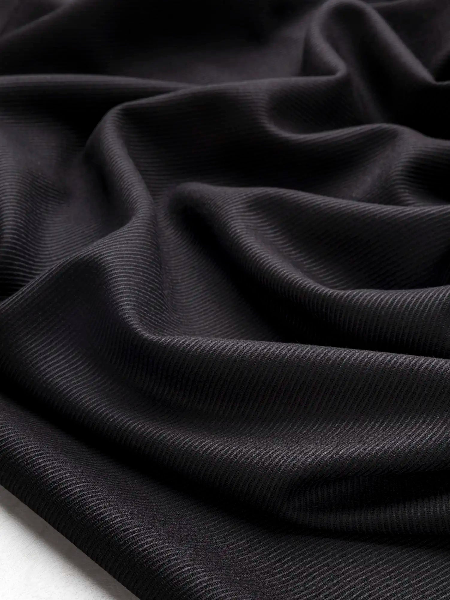 F-WOL157-002-Wool-Twill-Italian-Suiting-Deadstock-Black-Core-Fabrics-scrunched.webp