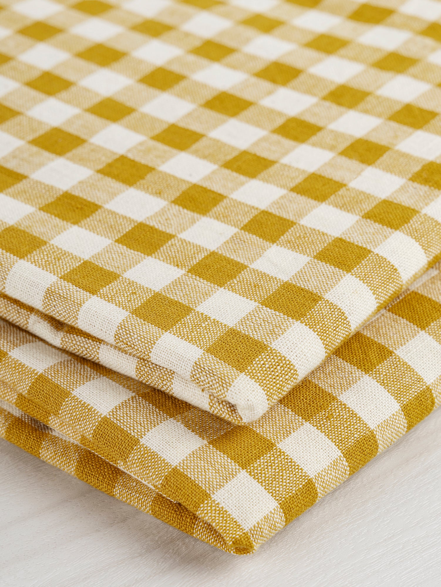 F-COT352-004-Yarn-Dyed-Handwoven-Gingham-Cotton-Ochre+Cream-Core-Fabrics-fold.JPG