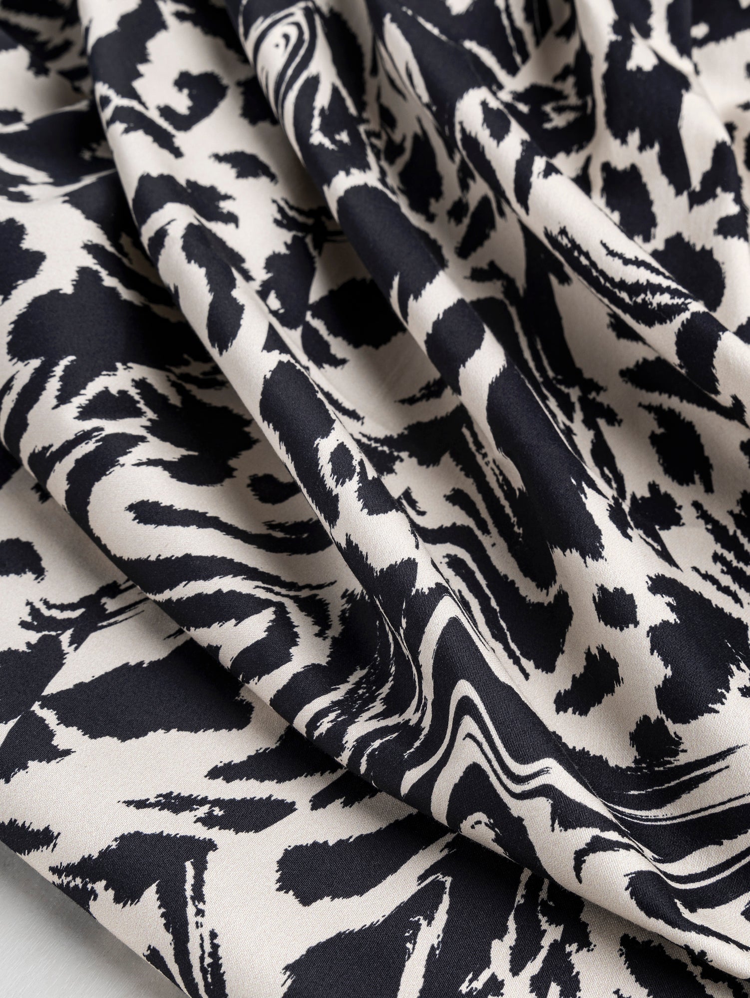 F-COT325-Zebra-Print-Stretch-Cotton-Bottomweight-Black-Cream-Core-Fabrics-scrunched