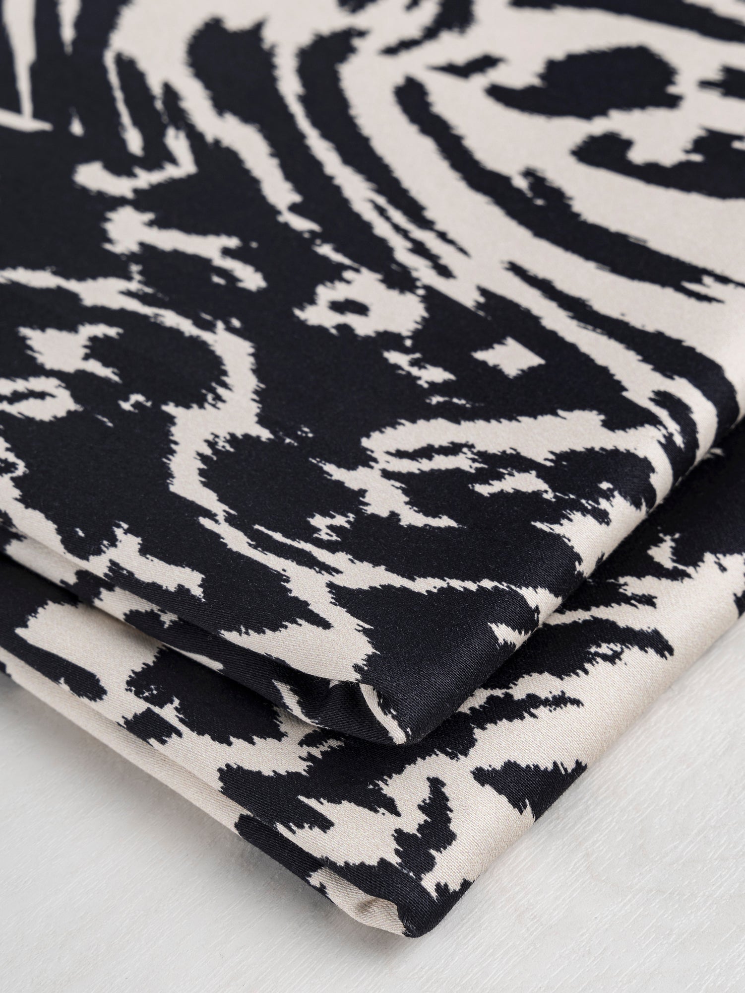 F-COT325-Zebra-Print-Stretch-Cotton-Bottomweight-Black-Cream-Core-Fabrics-fold