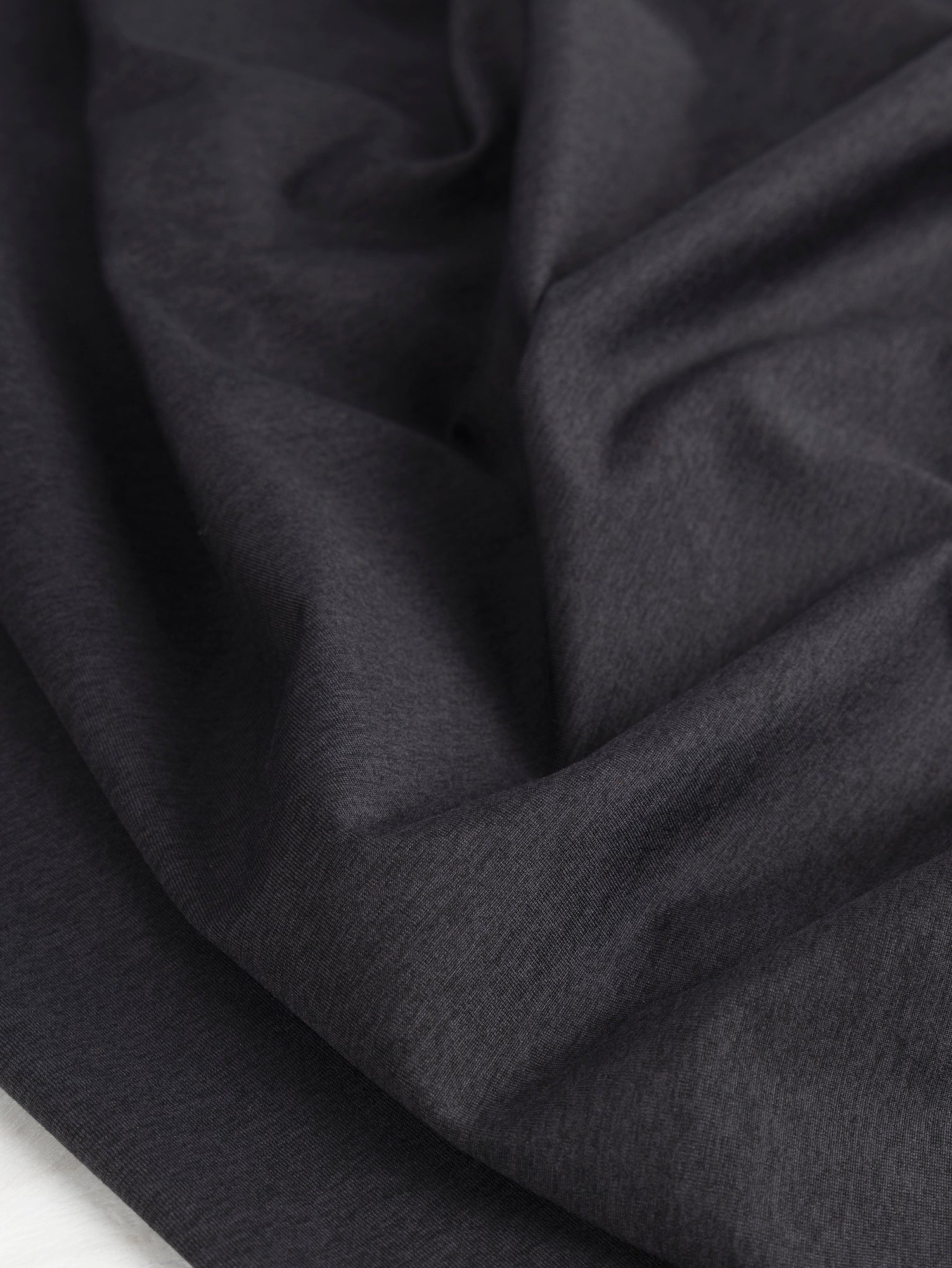 F-PES033-002-rPet-Poly-Performance-Stretch-Knit-Deadstock-Heather-Black-Core-Fabrics-scrunched.JPG