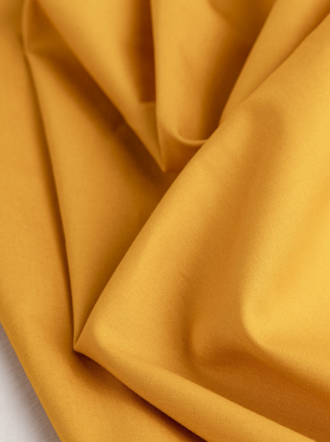 https://corefabricstore.com/cdn/shop/products/Core-Collection-Lightweight-Silky-Cotton-Poplin-Gold--Core-Fabrics.jpg?v=1676096860&width=1122