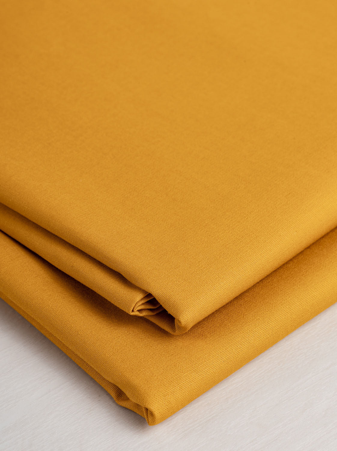https://corefabricstore.com/cdn/shop/products/Core-Collection-Lightweight-Silky-Cotton-Poplin-Gold--Core-Fabrics_b84e0381-49b9-4c55-9912-8dc56d8f10e8_2048x.jpg?v=1676096865