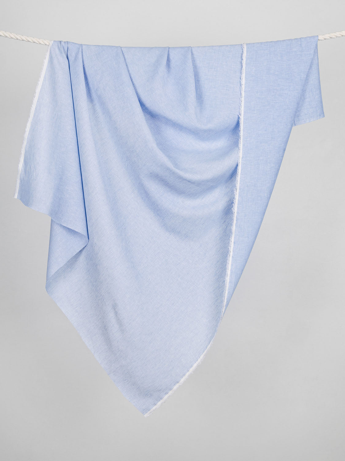 F-LIN025-003-Yarn-Dyed-Chambray-Linen-Powder-Blue-Core-Fabrics-draped.jpg